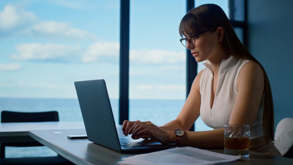 Successful freelancer working online in office. Focused businesswoman typing